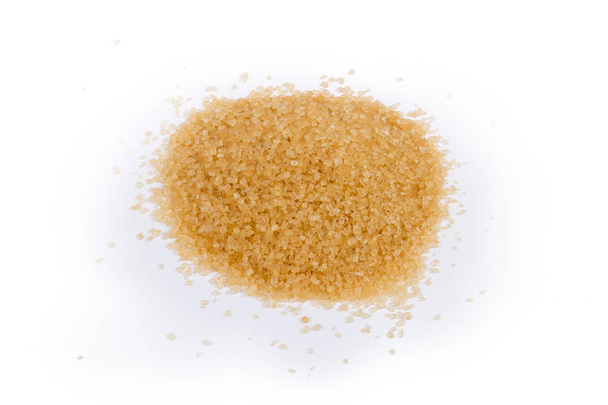 Punhado do açúcar mascavo em uma superfície de cor clara
 - Foto, Imagem