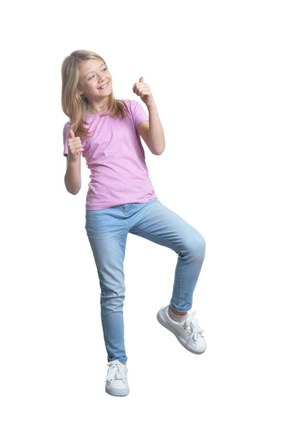 Full length portrait of cute girl in casual clothing showing thumbs up isolated on white background - Фото, изображение
