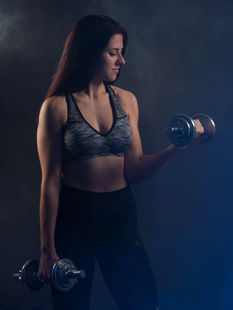 Active young woman workout with dumbbells  - Foto, Bild