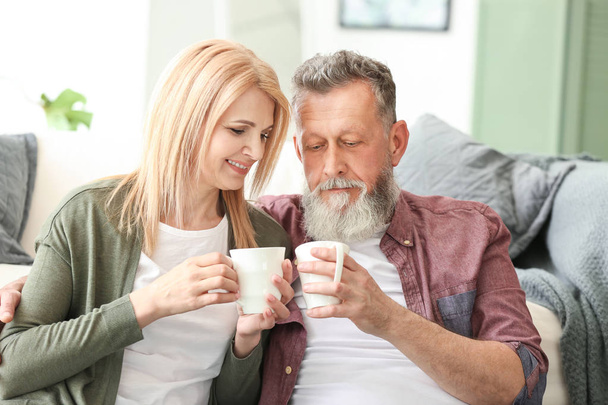 Happy elderly couple drinking tea at home - Photo, Image