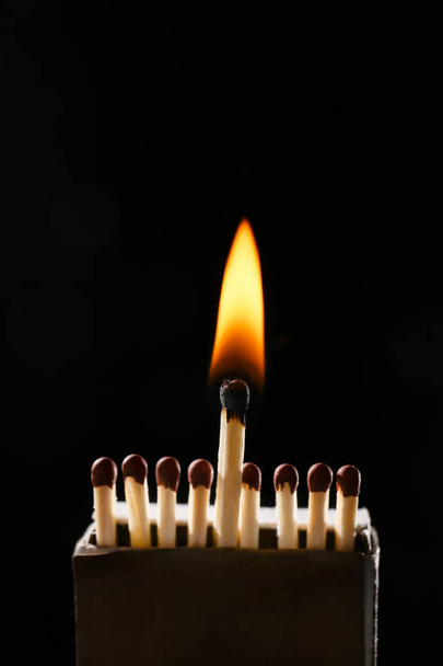 Box with matches and flame on dark background - Photo, Image