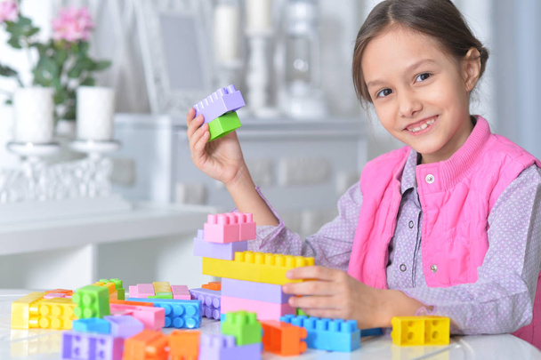 little girl playing with colorful plastic blocks - Zdjęcie, obraz