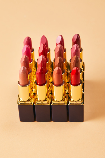 close up of various lipsticks on beige  - Foto, Imagem