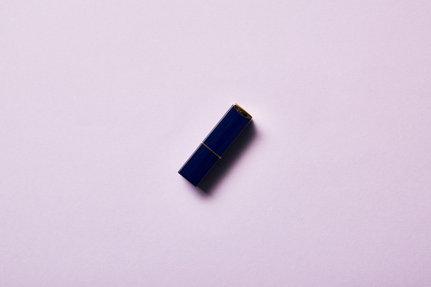 top view of one tube of lipstick on purple - Фото, зображення