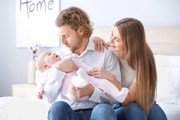 Happy parents with cute little baby at home - Photo, Image
