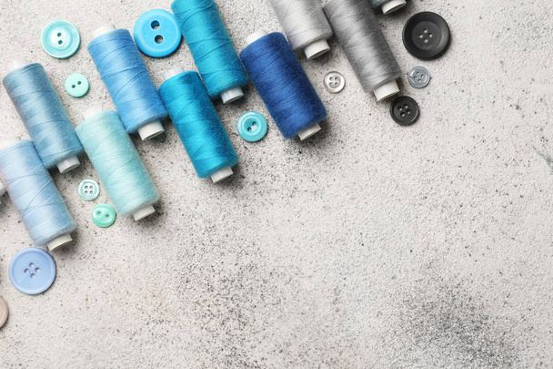 Set of sewing threads and buttons on light background - Foto, immagini
