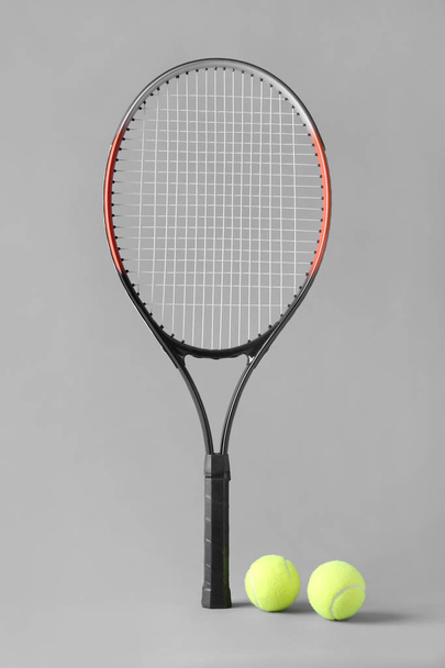 Tennis racket and balls on grey background - Фото, изображение