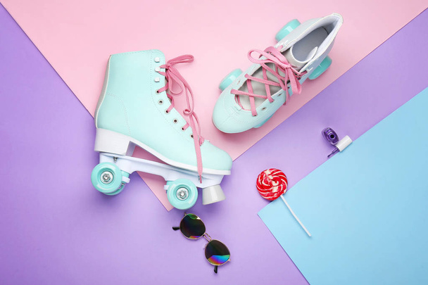 Vintage roller skates and accessories on color background - Fotoğraf, Görsel