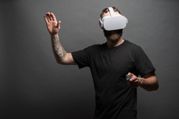 Man hipster with beard using virtual reality glasses - Фото, изображение