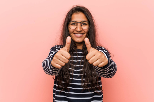 Young intellectual indian woman with thumbs ups, cheers about something, support and respect concept. - Photo, Image