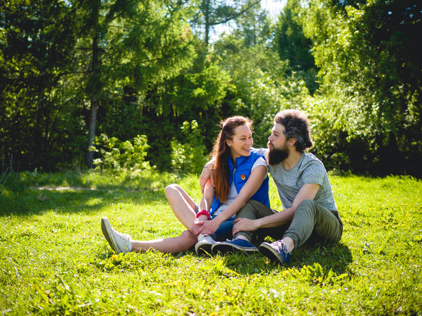 Couple on the grass in the park - Фото, зображення