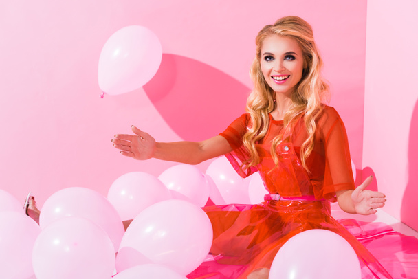 beautiful happy girl posing near balloons on pink, doll concept - Foto, Imagen