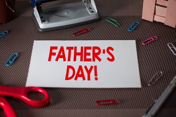 Text sign showing Father S Day. Conceptual photo day of year where fathers are particularly honoured by children Scissors and writing equipments plus plain sheet above textured backdrop. - Photo, Image