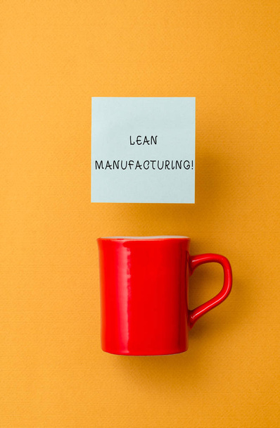 Conceptual hand writing showing Lean Manufacturing. Business photo text Waste Minimization without sacrificing productivity Front view coffee cup colored sticky note yolk color background. - Photo, Image