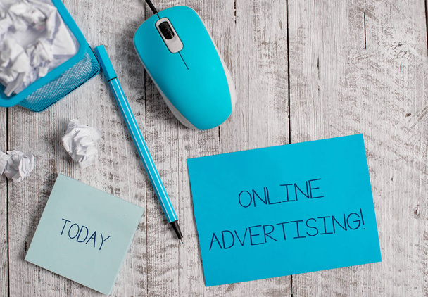 Conceptual hand writing showing Online Advertising. Business photo showcasing Internet Web Marketing to Promote Products and Services Crumpled paper in bin and computer mouse on wooden backdrop. - Photo, Image