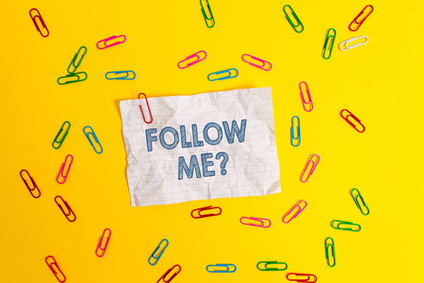 Text sign showing Follow Me Question. Conceptual photo go or come after demonstrating or thing proceeding ahead Blank crushed paper sheet message clips binders plain colored background. - Photo, Image