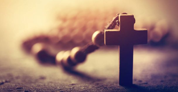 Wooden cross and rosary on stone background. - Photo, Image
