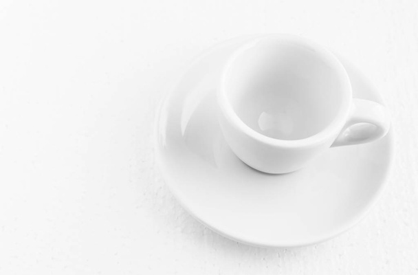 closeup top view on white coffee cup and saucer, empty coffee-free coffee cup, for black coffee, on a white background - Фото, изображение