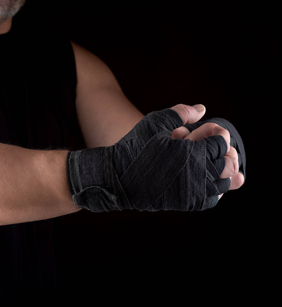 two men's hands wrapped in black sports textile bandage - Φωτογραφία, εικόνα