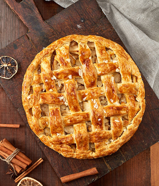 sült egész kerek almás pite, egy barna fa tábla - Fotó, kép