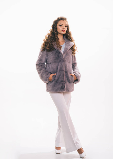 When fashion meets aesthetic beauty. Fashion model wear luxurious fur. Pretty woman in fashionable fur coat. Winter fashion trends. Young woman wear elegant winter coat. Perfect for winter cold - Valokuva, kuva