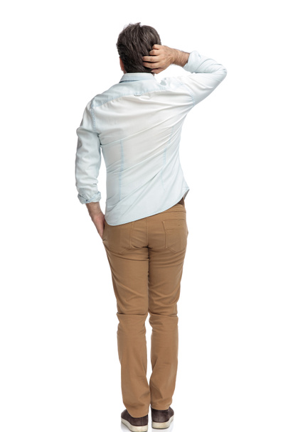 Back view of concerned casual man scratching his head - Photo, Image