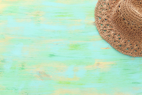 Beach fashion female hat over mint wooden background. Tropical summer vacation concept. top view, flat lay - 写真・画像