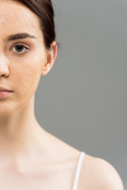cropped view of brunette young woman with face scrub on skin  - Fotó, kép