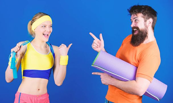 Lets do this. Athletic Success. Strong muscles and body. Sporty couple training with fitness mat and jump rope. Sport equipment. Happy woman and bearded man workout in gym. we will make it together - Фото, зображення