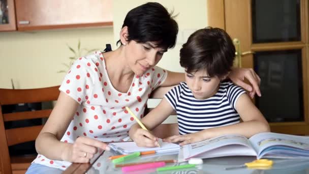 Middle-aged mother helps her daughter with her homework. - Footage, Video
