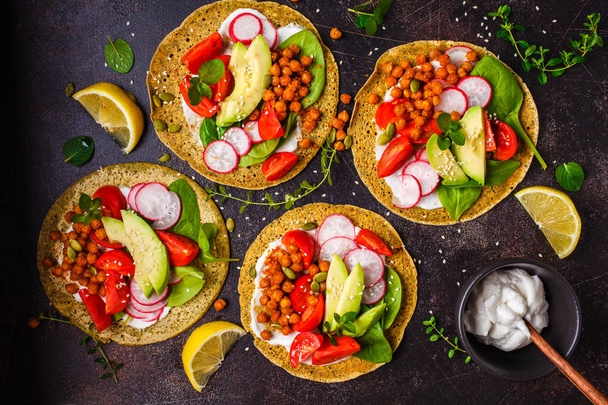 Vegan tacos with baked chickpeas, avocado, sauce and vegetables  - Фото, изображение
