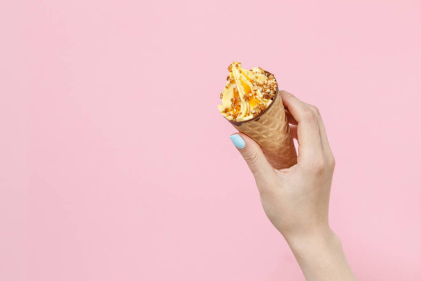 Woman holding Ice Cream in a waffles cone on color background. - Fotografie, Obrázek