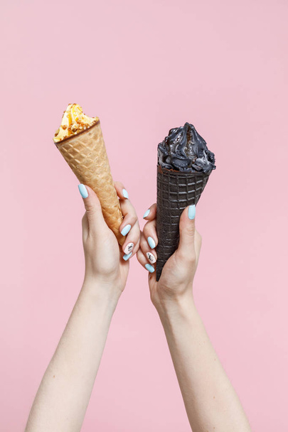 Woman holding Ice Cream in a waffles cones on color background. - Fotó, kép