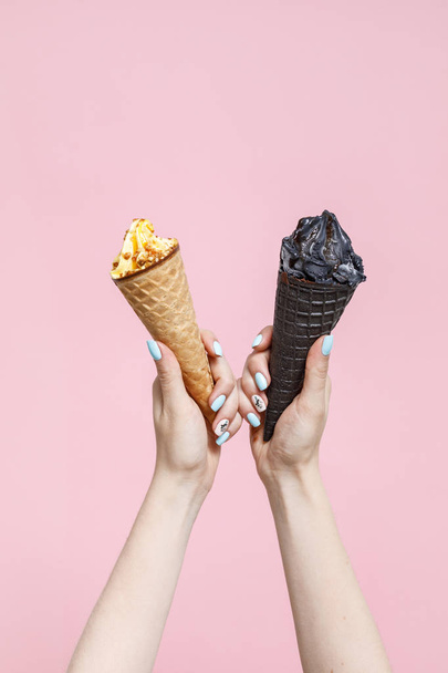 Woman holding Ice Cream in a waffles cones on color background. - Фото, изображение