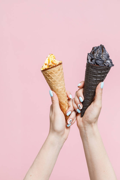 Woman holding Ice Cream in a waffles cones on color background. - Photo, image