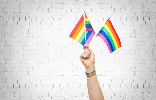 hand with gay pride rainbow flags and wristband - Fotoğraf, Görsel