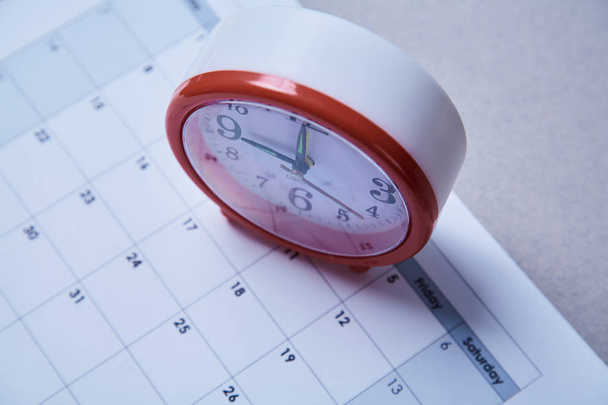 Time management deadline and schedule concept: alarm clock on schedule plan - Photo, Image