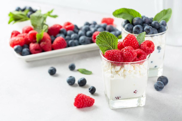 Cottage cheese with cream, raspberry and blueberry garnished wit - Photo, Image