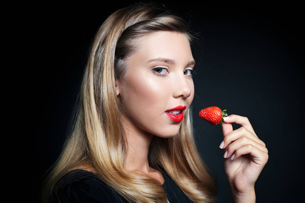 Beautiful young woman holding strawberry  - Zdjęcie, obraz
