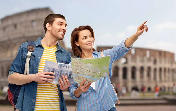 happy couple of tourists with city guide and map - Photo, Image