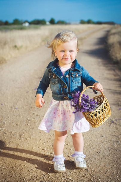 Little girl with lavender flower bouquet - Fotó, kép