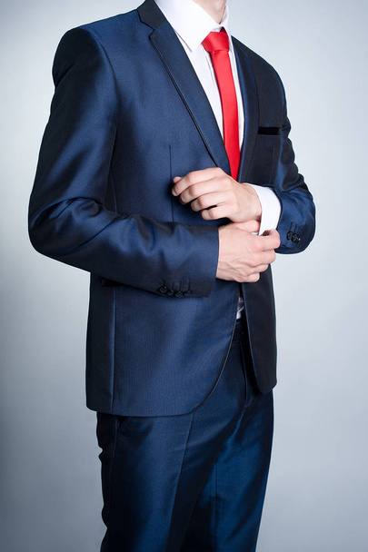 Nierozpoznawalny biznesmen w ciemnoniebieskim kolorze z czerwonym krawatem  - Zdjęcie, obraz