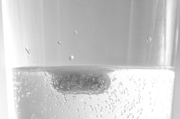 Effervescent tablet dissolving in a glass of water - Photo, Image
