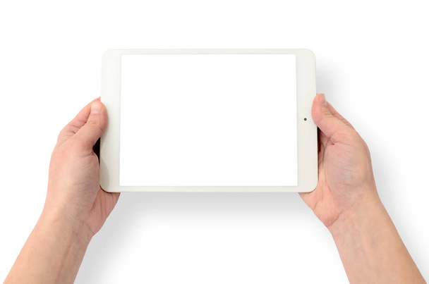 Manos sosteniendo un gadget sobre un fondo blanco. Tablet ordenador, dispositivo inalámbrico
. - Foto, Imagen
