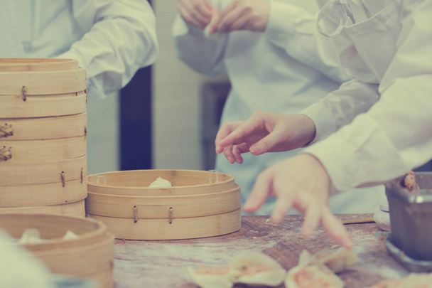 Dim Sum koks werken Wrapping dumplings in het beroemde restaurant in - Foto, afbeelding