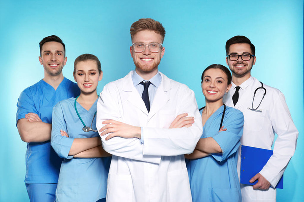 Group of medical doctors on color background. Unity concept - Φωτογραφία, εικόνα