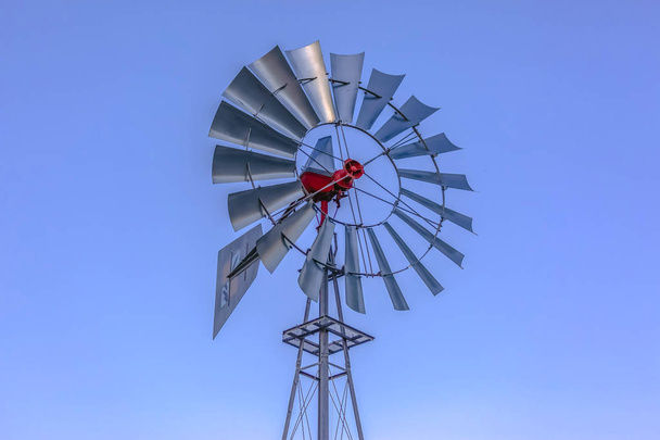 Looking up at aluminum windmill sky behind - Photo, Image