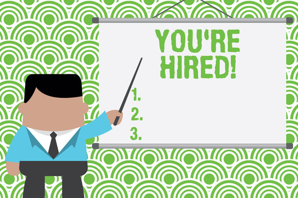 Text sign showing You Re Hired. Conceptual photo Used by huanalysis resources indicate employee that he is got job Businessman standing in front projector screen pointing project idea. - Photo, Image
