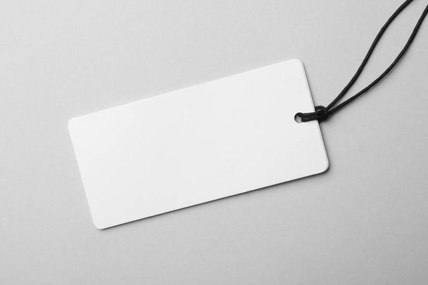 Cardboard tag with space for text on light background, top view - Foto, Bild