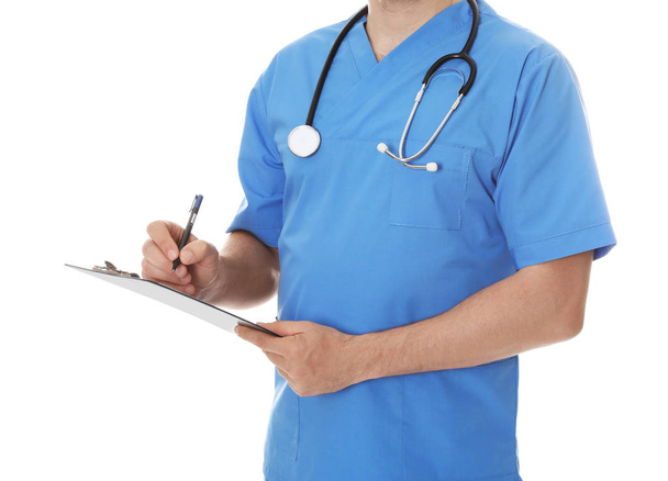 Closeup of male doctor in scrubs with stethoscope and clipboard isolated on white. Medical staff - Foto, Imagem